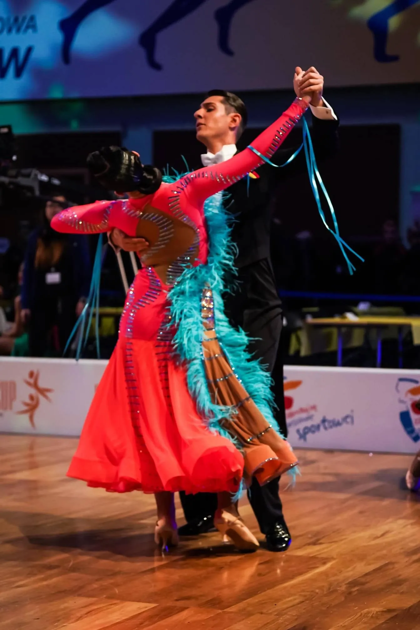 Vibrant Ballroom Dress in Orange with Blue Feathers